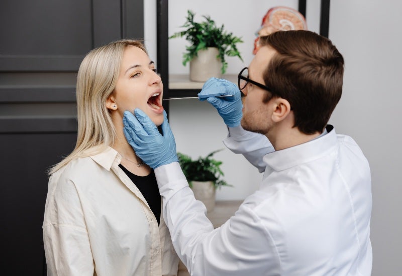 A dentist conducts a dental examination of a patient in Fairfax, VA.