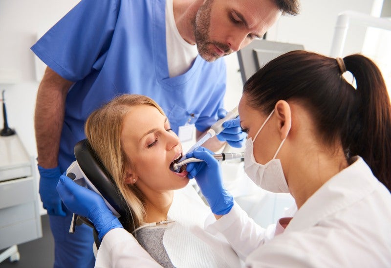 Young woman is getting treatment in dentist's office in Fairfax, VA
