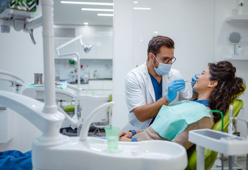 A dental professional providing general dental services to a patient in Fairfax, VA.